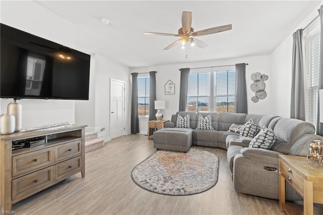 living room with ceiling fan and light hardwood / wood-style floors