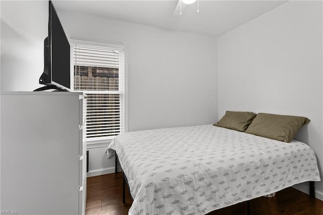 bedroom with ceiling fan and dark hardwood / wood-style floors