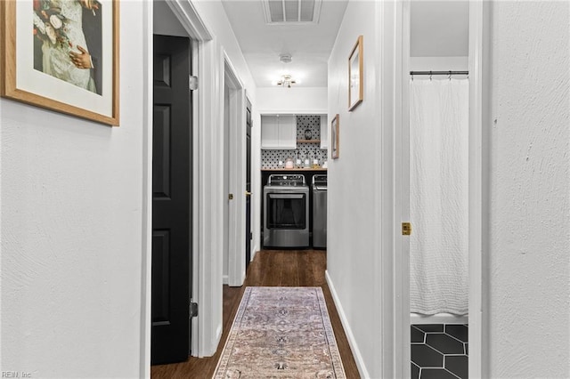 hall featuring dark wood-type flooring and washer and dryer