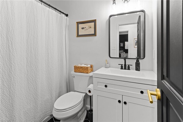 bathroom featuring toilet and vanity