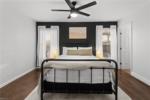 bedroom with ceiling fan and dark wood-type flooring