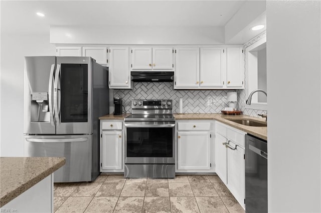 kitchen with white cabinetry, stainless steel appliances, sink, backsplash, and light stone counters