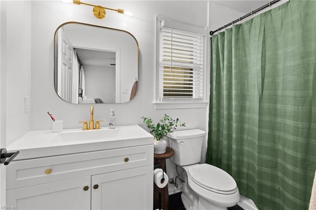 bathroom featuring toilet and vanity