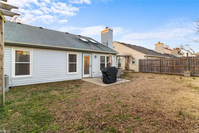 back of property featuring a patio area, cooling unit, and a yard