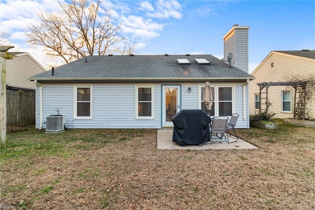 rear view of house featuring central air condition unit, a patio area, a lawn, and a pergola