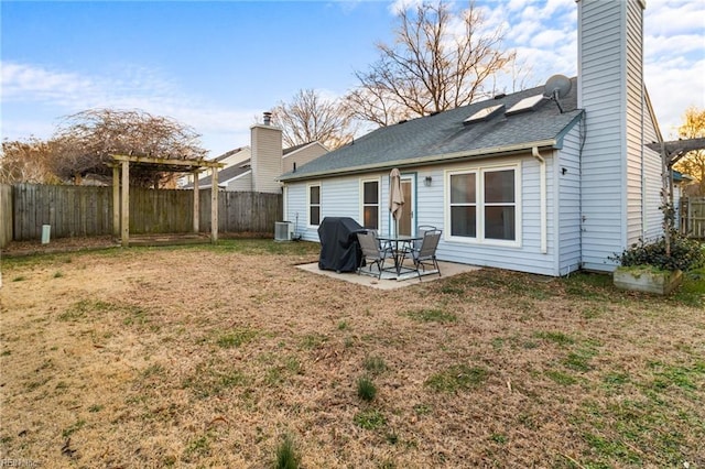 back of house featuring central AC unit, a lawn, and a patio