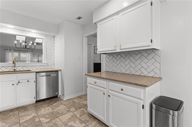 kitchen featuring decorative backsplash, sink, white cabinets, and dishwasher