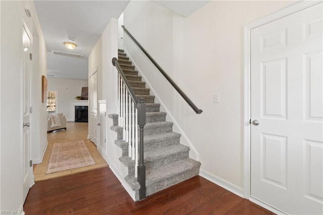 staircase featuring wood-type flooring