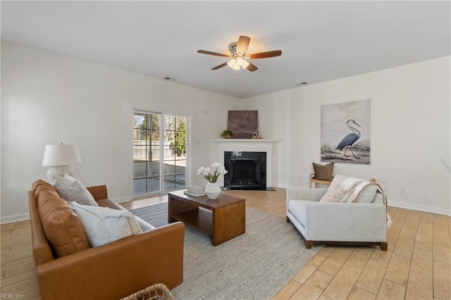 living room with ceiling fan and light hardwood / wood-style floors