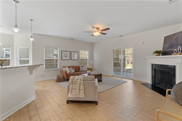 living room featuring ceiling fan and light hardwood / wood-style flooring