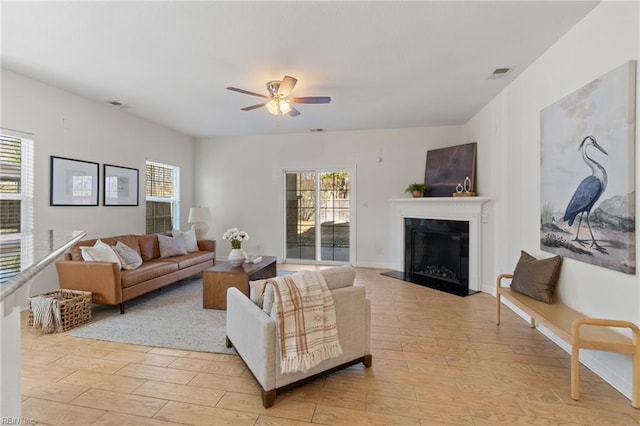 living room with ceiling fan and light hardwood / wood-style flooring