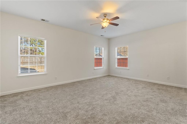 carpeted spare room with ceiling fan