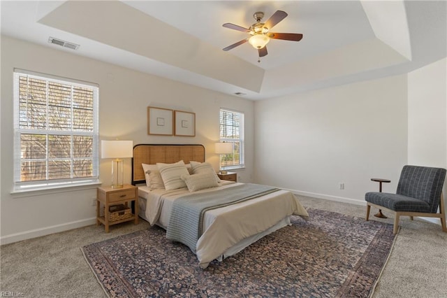 bedroom featuring carpet floors, ceiling fan, and a tray ceiling