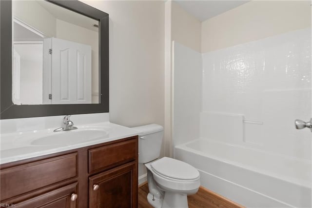 full bathroom featuring shower / bath combination, toilet, vanity, and wood-type flooring