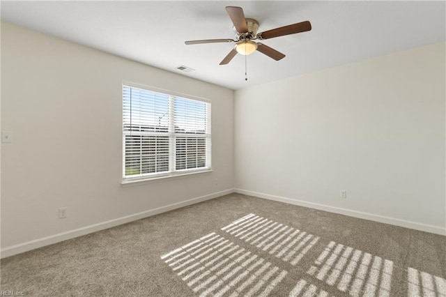 carpeted spare room featuring ceiling fan