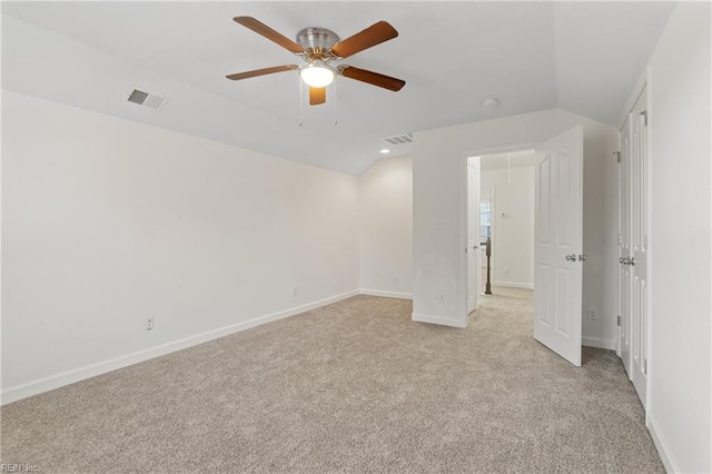 carpeted empty room featuring ceiling fan and lofted ceiling