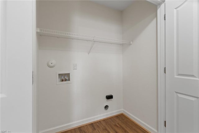 clothes washing area with washer hookup, gas dryer hookup, and wood-type flooring