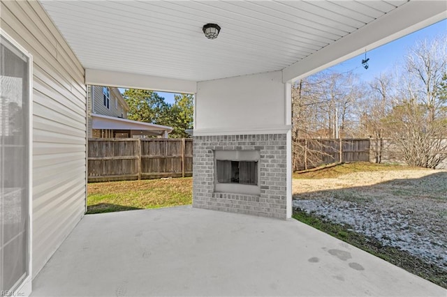 view of patio featuring an outdoor brick fireplace