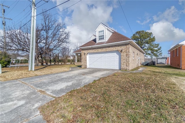 view of side of property featuring a yard and a garage