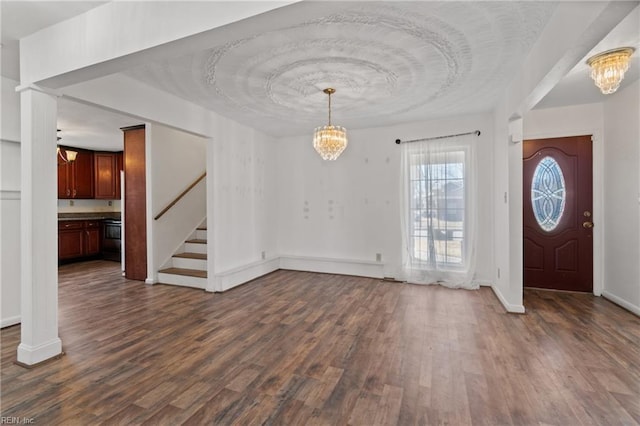 foyer featuring a notable chandelier and dark hardwood / wood-style flooring