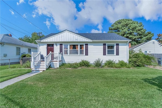 bungalow-style home with a front lawn