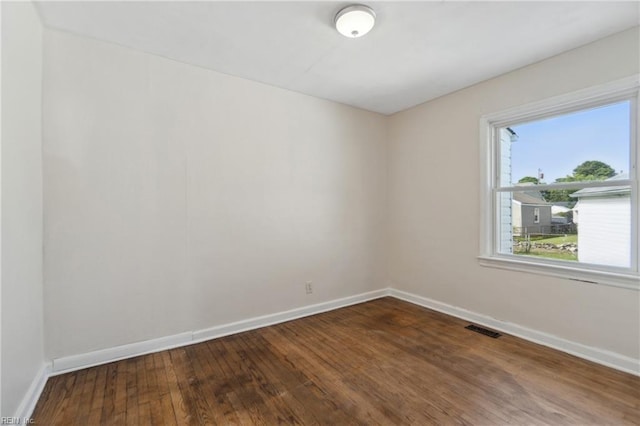 spare room with hardwood / wood-style floors