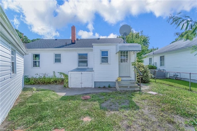 rear view of house with a lawn