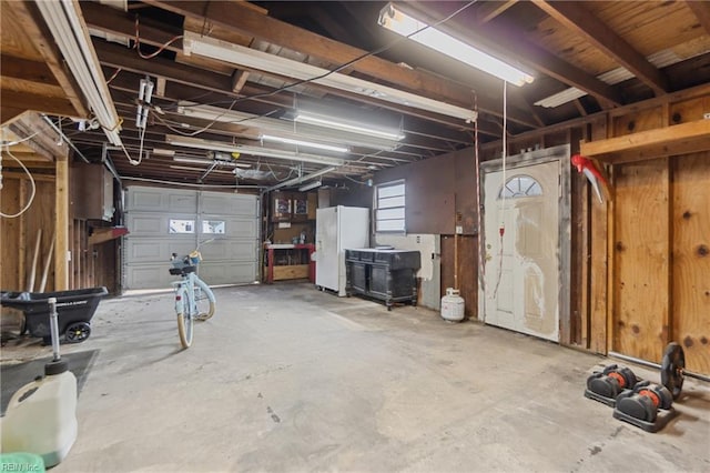 garage featuring white fridge with ice dispenser