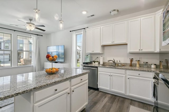 kitchen featuring dark hardwood / wood-style flooring, white cabinets, appliances with stainless steel finishes, ceiling fan, and sink