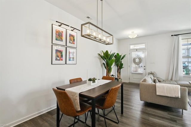 dining space with dark hardwood / wood-style floors