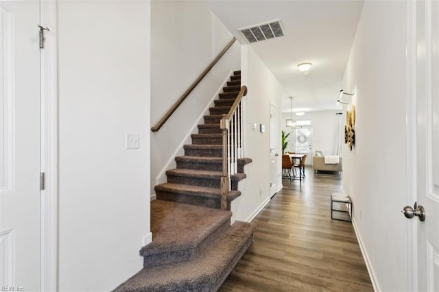 stairway featuring hardwood / wood-style floors