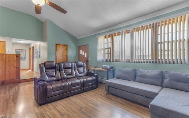 living room with ceiling fan, hardwood / wood-style floors, and lofted ceiling