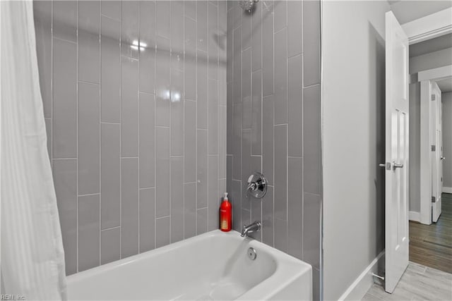 bathroom with hardwood / wood-style floors and shower / bath combo