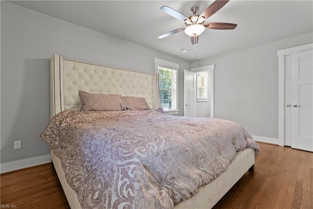 bedroom with ceiling fan and dark hardwood / wood-style floors