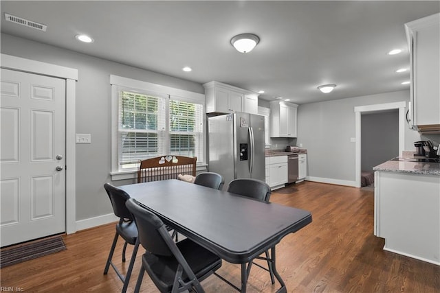 dining space with dark hardwood / wood-style floors