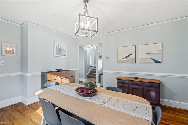 dining room with an inviting chandelier and wood-type flooring