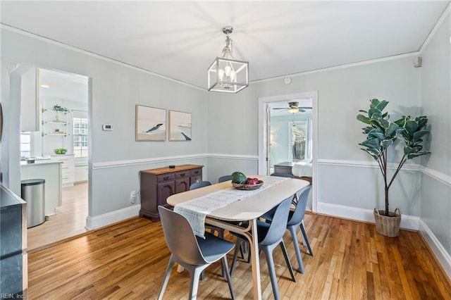 dining space with an inviting chandelier and light hardwood / wood-style flooring