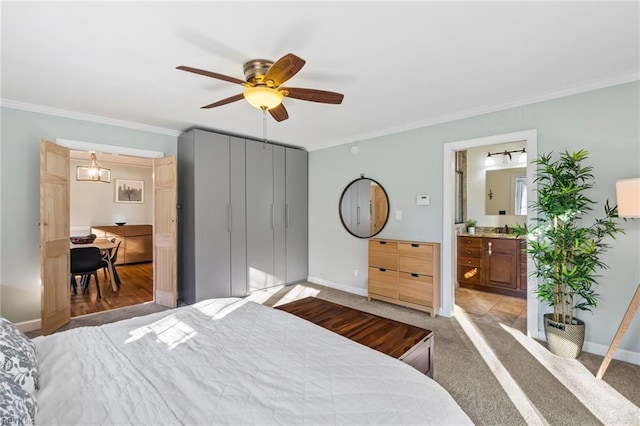 bedroom featuring connected bathroom, ceiling fan, crown molding, and light colored carpet