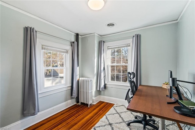 home office with ornamental molding, radiator heating unit, and hardwood / wood-style floors