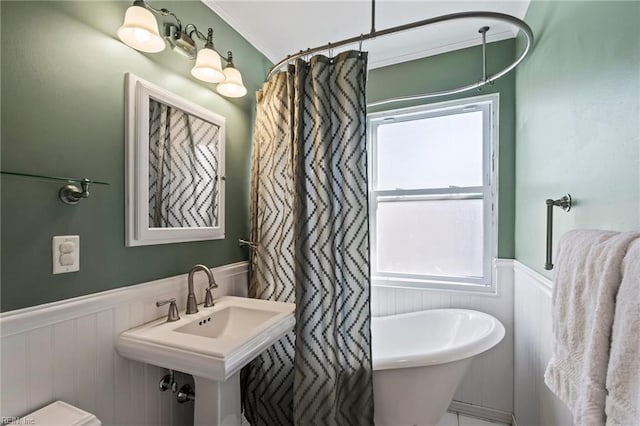 bathroom featuring toilet and ornamental molding