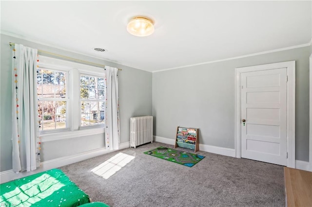 game room with crown molding, carpet floors, and radiator