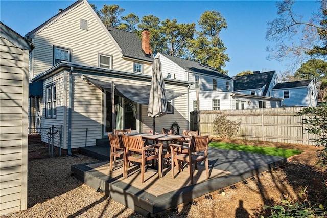 back of house featuring a wooden deck