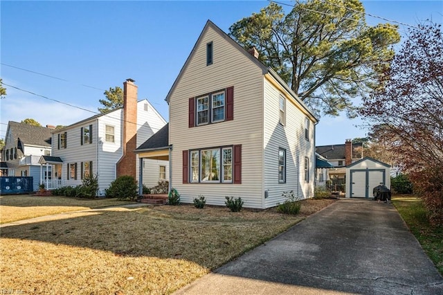 view of front of property with a front lawn and a storage shed