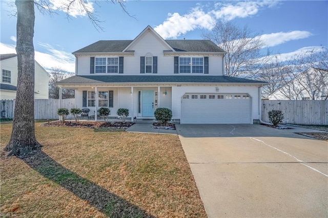 view of property with covered porch, a garage, and a front yard