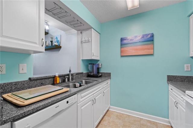 kitchen featuring sink, white dishwasher, white cabinetry, and a textured ceiling