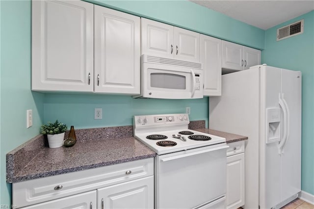 kitchen with white appliances and white cabinets