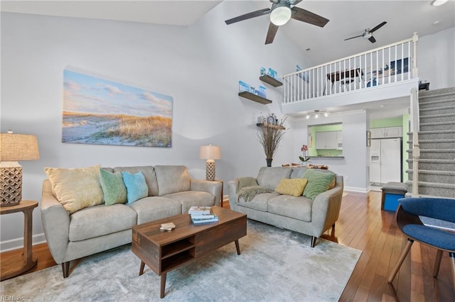 living room featuring ceiling fan, high vaulted ceiling, and wood-type flooring