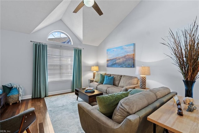 living room featuring ceiling fan, vaulted ceiling, and dark wood-type flooring