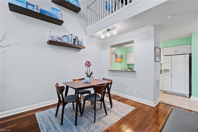 dining room with ornamental molding and hardwood / wood-style floors