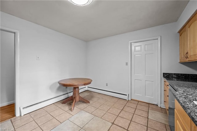 tiled dining room with baseboard heating